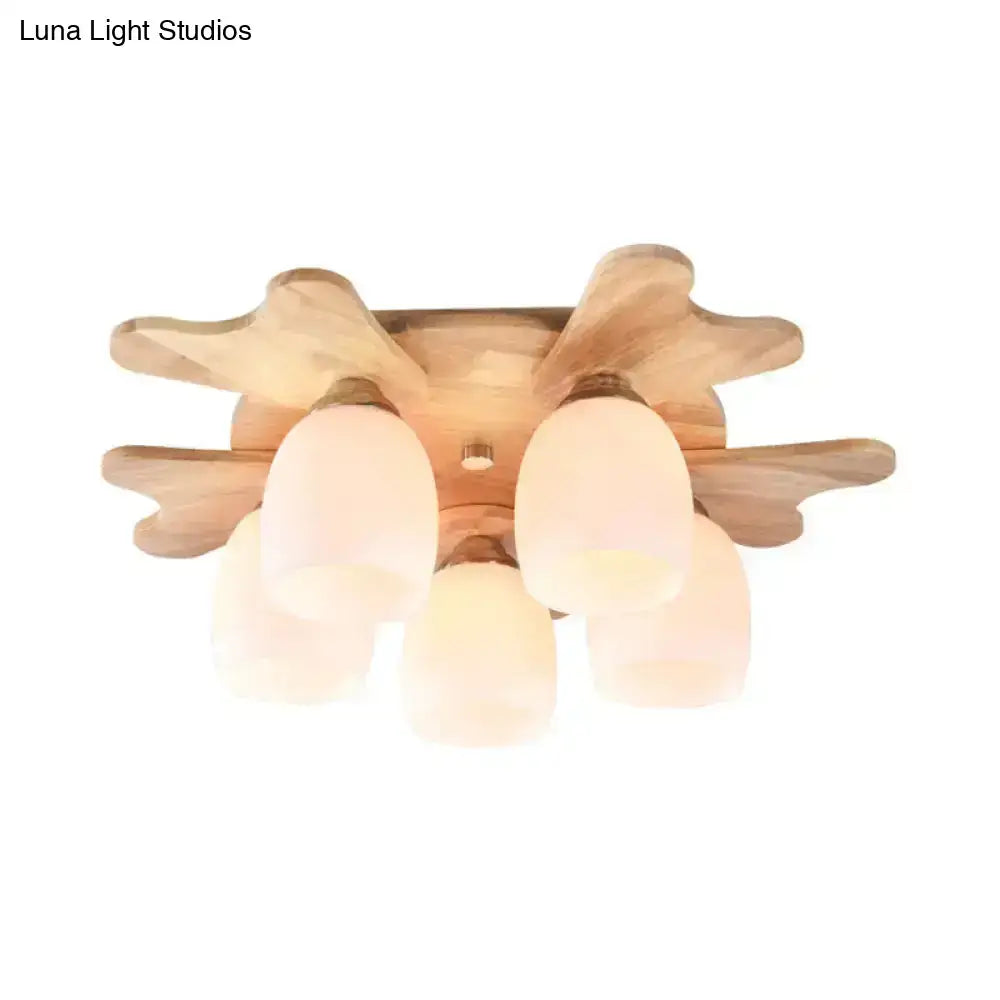 Nordic ceiling light with natural wood antler base and five cream glass bell frosted shades for bedroom