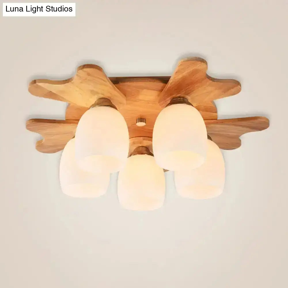 Wooden ceiling light fixture with five cream glass bell frosted shades and a natural wood finish for bedroom use