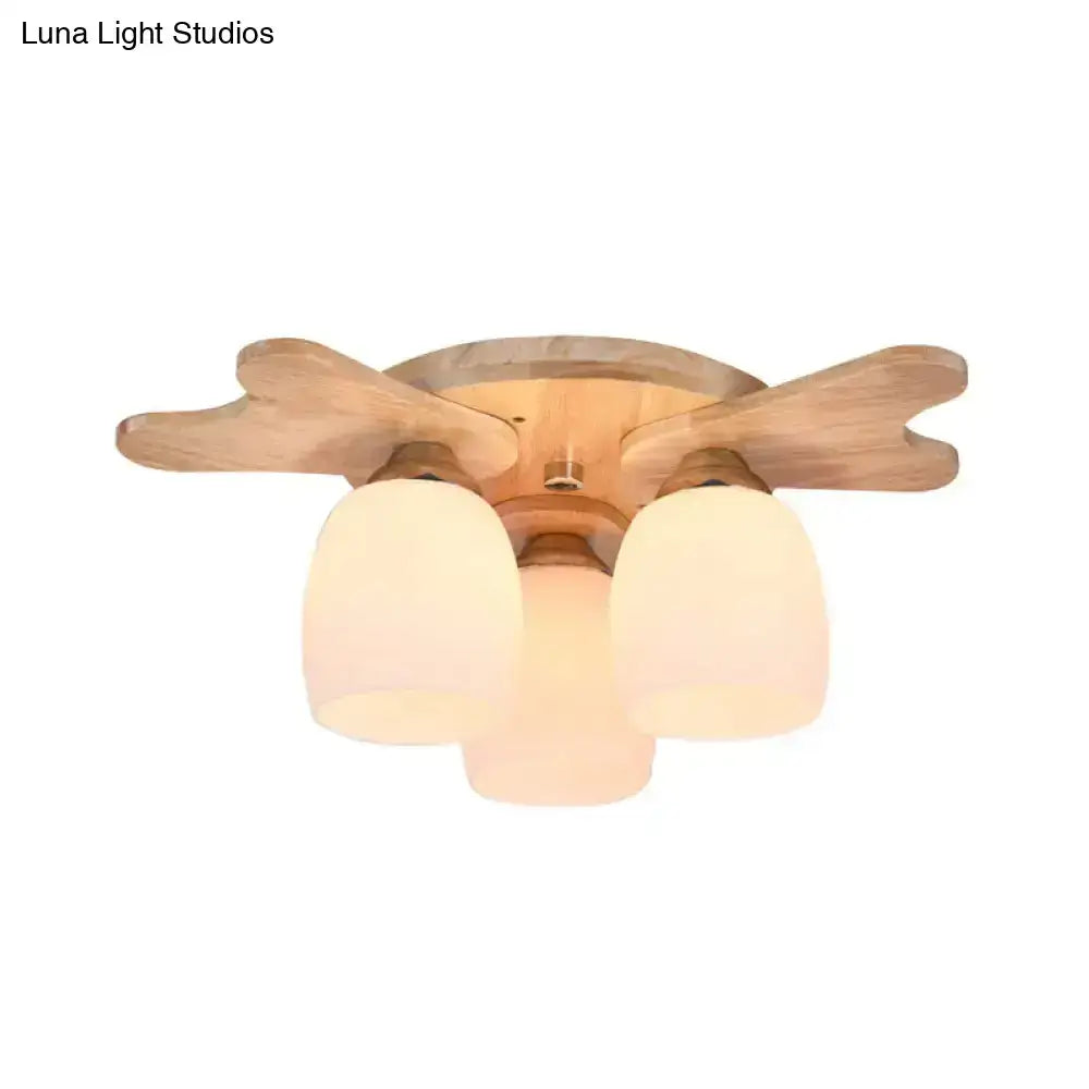Nordic cream glass bell ceiling light with light wood finish and three frosted cream glass shades for bedroom