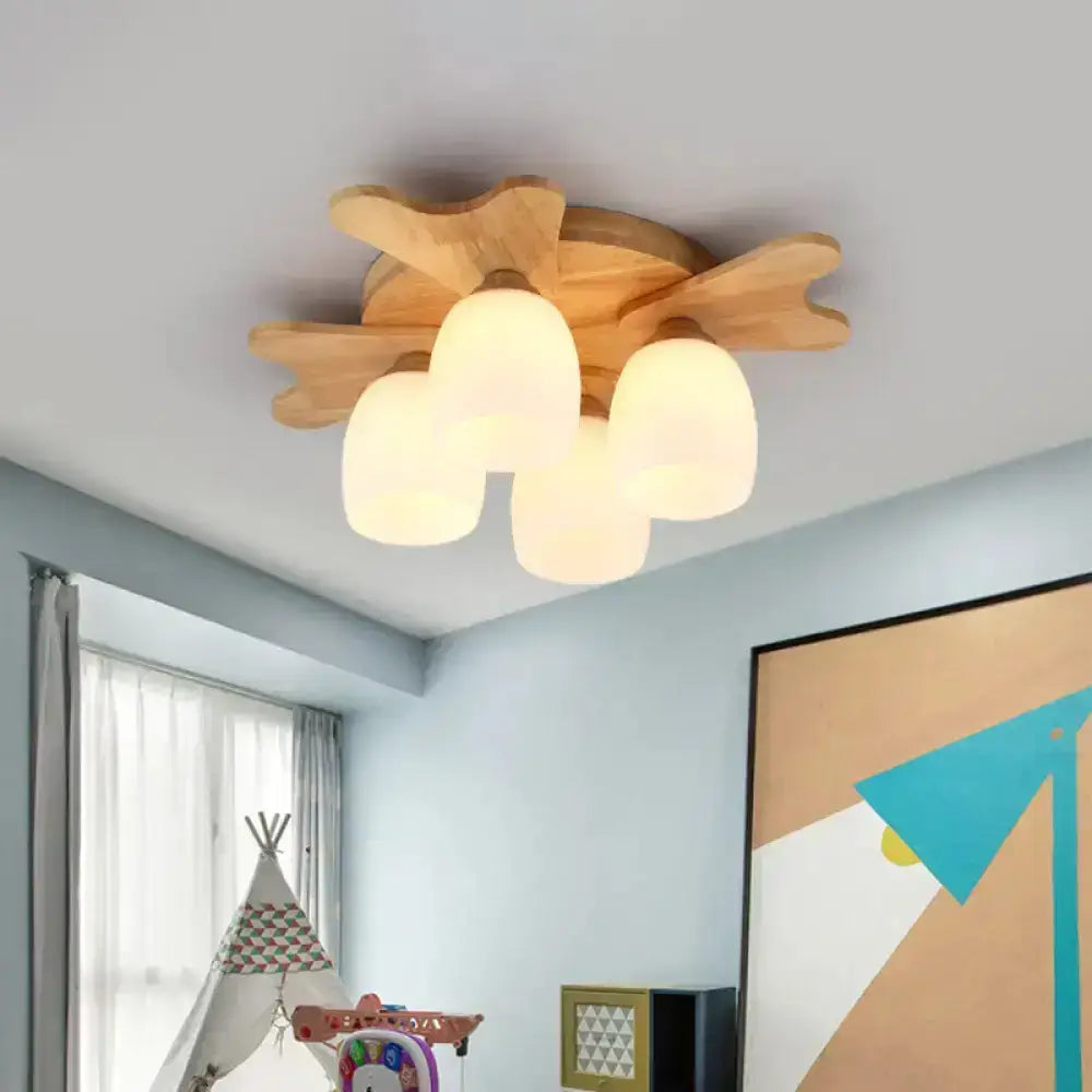 Wooden cloud-shaped ceiling light with three frosted cream glass bell globes for bedroom use