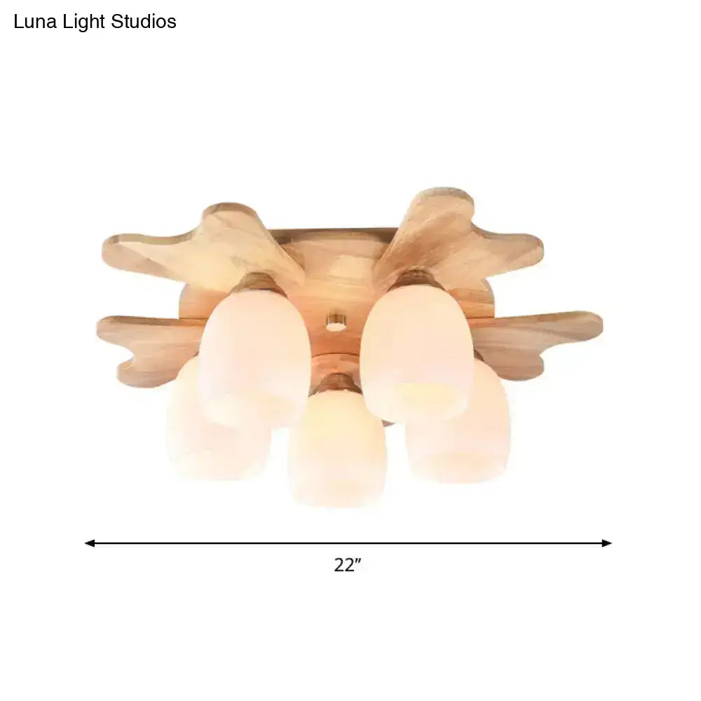 Nordic ceiling light with wood antler base and five cream glass bell frosted shades for bedroom lighting