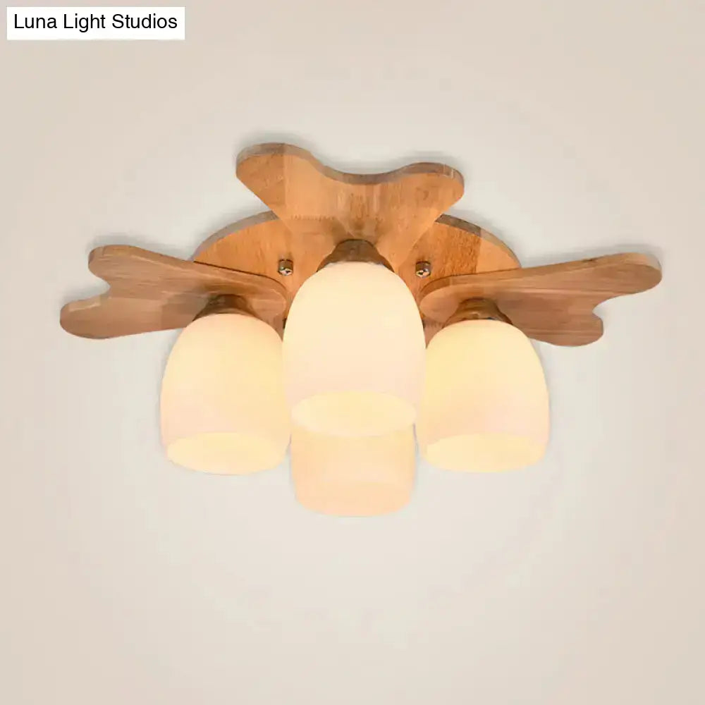 Nordic cream glass bell ceiling light with wooden antler arms and three frosted cream glass shades for bedroom