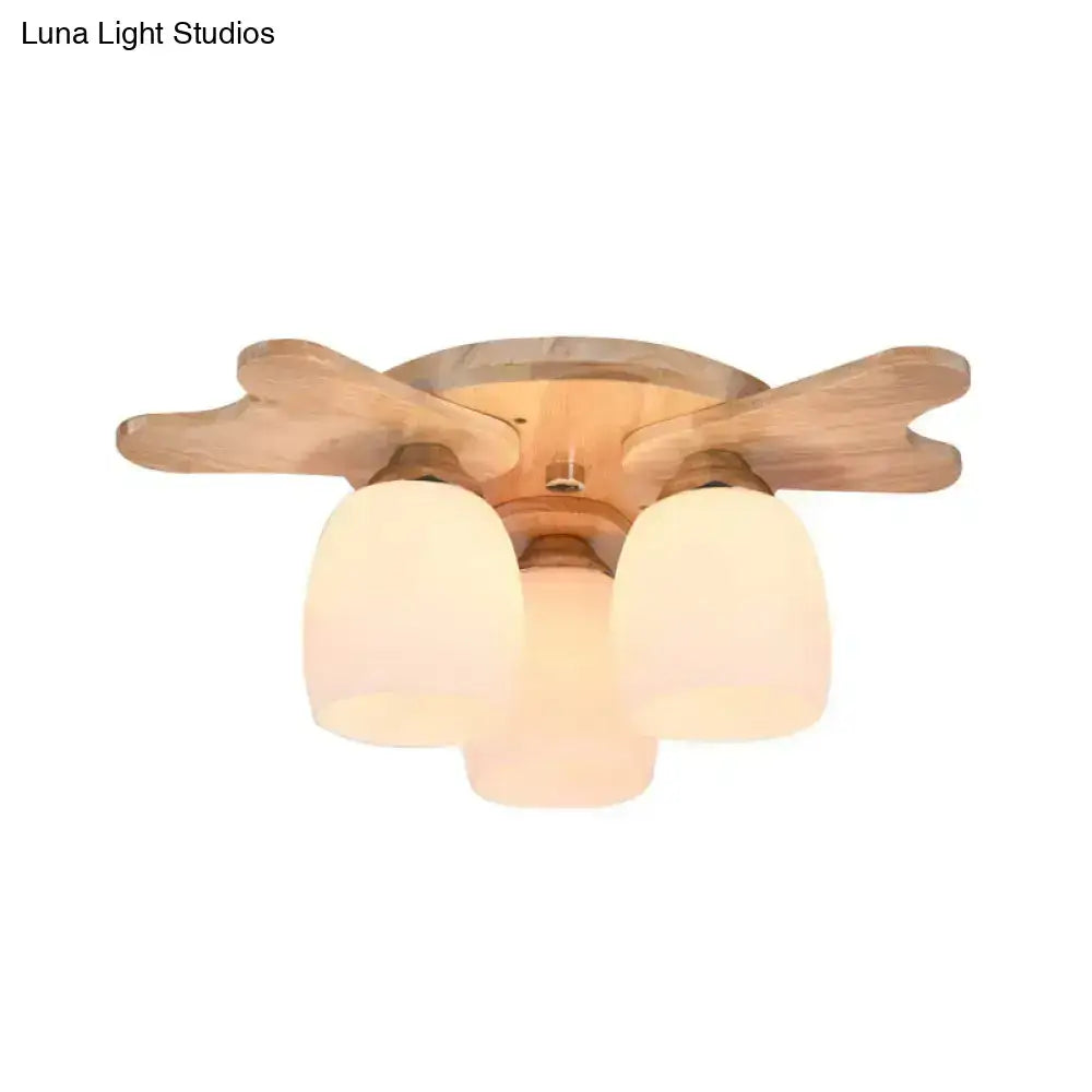 Light wood-finish ceiling fan with cream glass bell shades and wood antler design for bedroom lighting