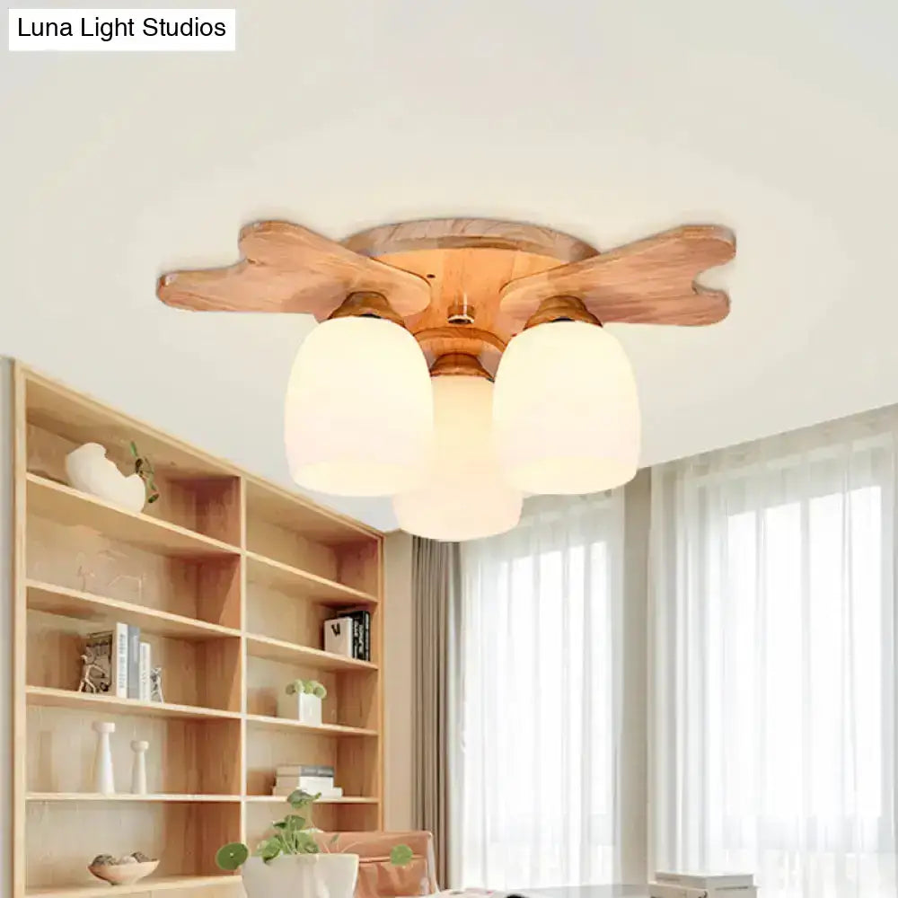 Wooden ceiling light with three cream glass bell shades and natural finish for nordic bedroom decor