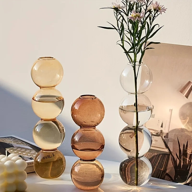 A nordic glass bubble vase made of translucent amber and clear glass spheres for home desk decor and flower arrangement