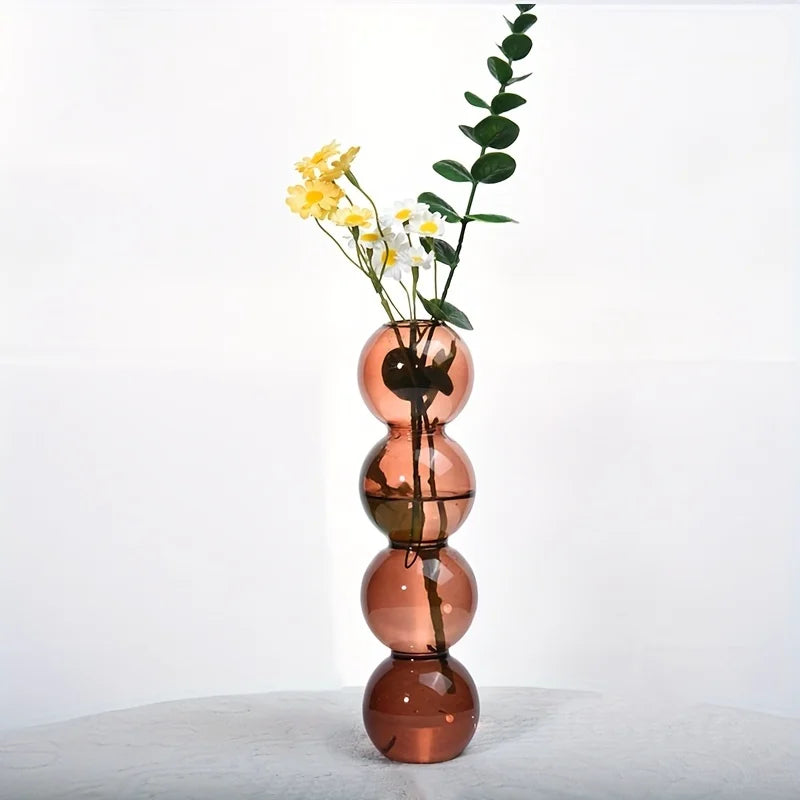 A tall amber-colored nordic glass bubble vase with four spherical segments for hydroponic planter and desk decor