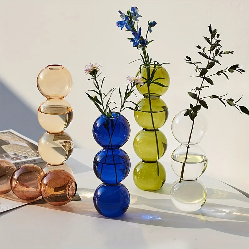 Stacked nordic glass bubble vases in amber cobalt blue and lime green translucent hues for hydroponic desk decor