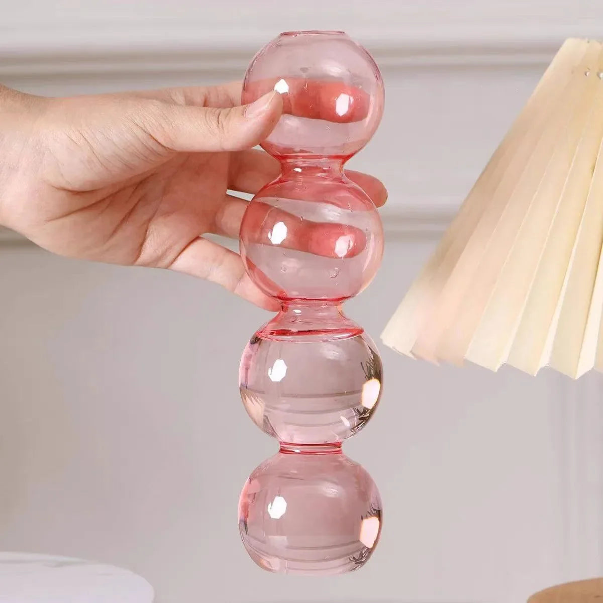 A translucent pink glass Nordic glass bubble vase with four stacked spheres for hydroponic planter decor