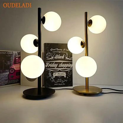Modern Nordic gold decorbites glass ball led table lamp with sleek black and gold stems and glowing white glass shades for bedroom