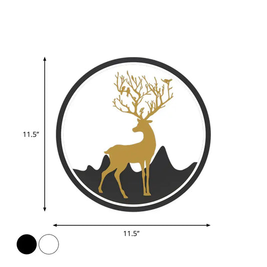 Circular wall decal featuring a gold deer with antlers adorned with birds, set against black mountain silhouettes within a white circle framed by a thick black border.
