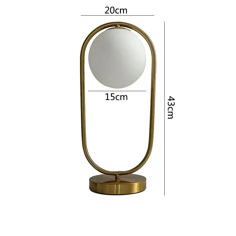 A nordic gold oval glass ball led desk lamp with a frosted glass ball and metal frame for bedroom decorbites glass ball