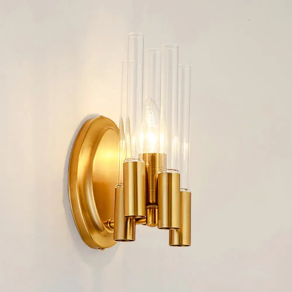 Gold-toned nordic wall lamp with five clear glass tubes and brass accents for living room lighting