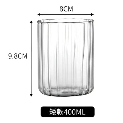 Clear glass ripple cup with vertical ribbed texture and flared rim in nordic design for dining room use