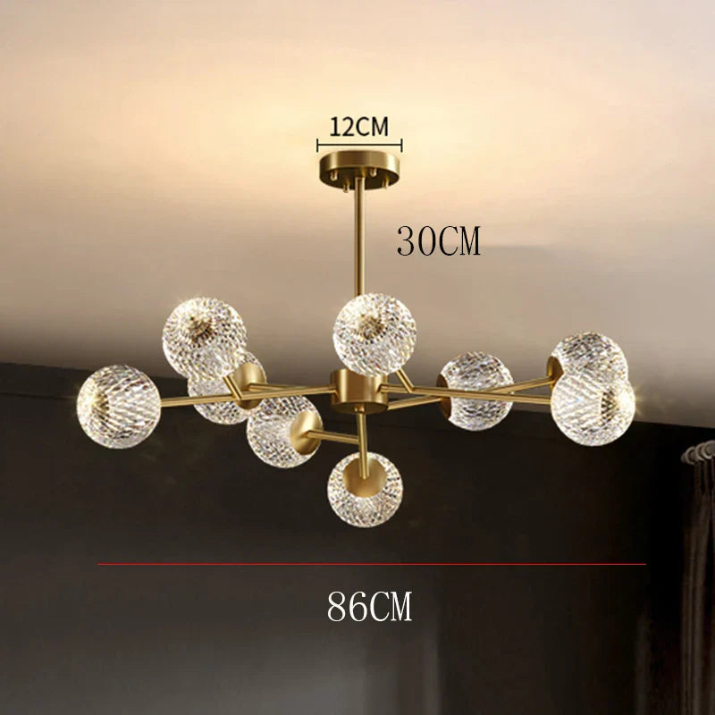 Gold-toned nordic chandelier with eight faceted crystal globe shades for dining room and living room lighting