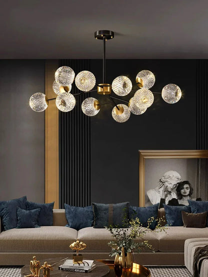 Gold-toned Nordic pendant chandelier with textured glass spheres suspended from a brass fixture for indoor dining room lighting