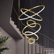 Golden spiral pendant light with illuminated rings in nordic home decor stair chandelier by decorbites nordic home