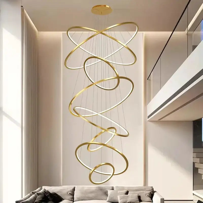 Golden spiral ring chandelier with interlocking rings and embedded led lighting for nordic home decor stair spaces