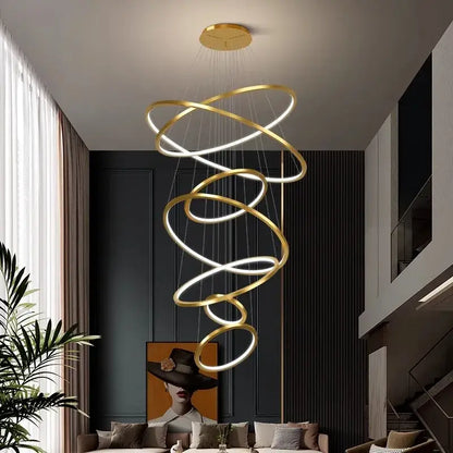 Golden spiral ring chandelier with illuminated rings in nordic home decor style for staircase lighting by decorbites nordic home