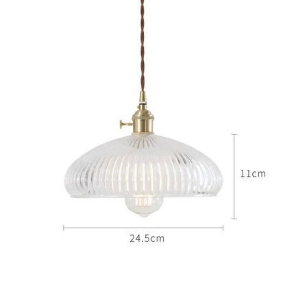 Clear ribbed glass pendant light with brass fixture and twisted brown cord in nordic japan style for dining room