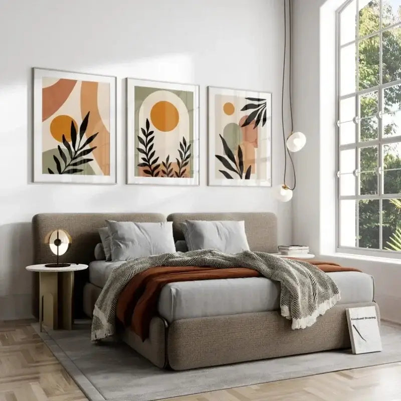 Beige upholstered bed with gray pillows and rust-colored throw blanket complementing decorbites abstract wall art