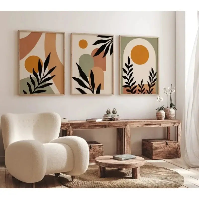 Cream-colored plush armchair with rounded contours and textured fabric next to decorbites™ abstract nordic leaf canvas wall art