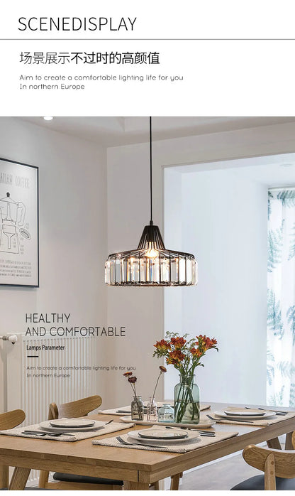 A modern black metal Nordic LED crystal pendant lamp with clear glass panels hanging above a wooden dining table