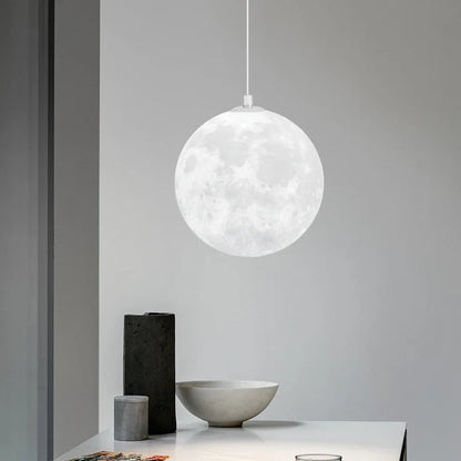 A white spherical nordic led moon pendant light with detailed lunar surface design for dining room kitchen decor