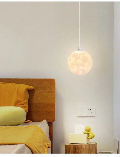 A warm glowing nordic led moon pendant light with textured surface for dining room kitchen and bar decor