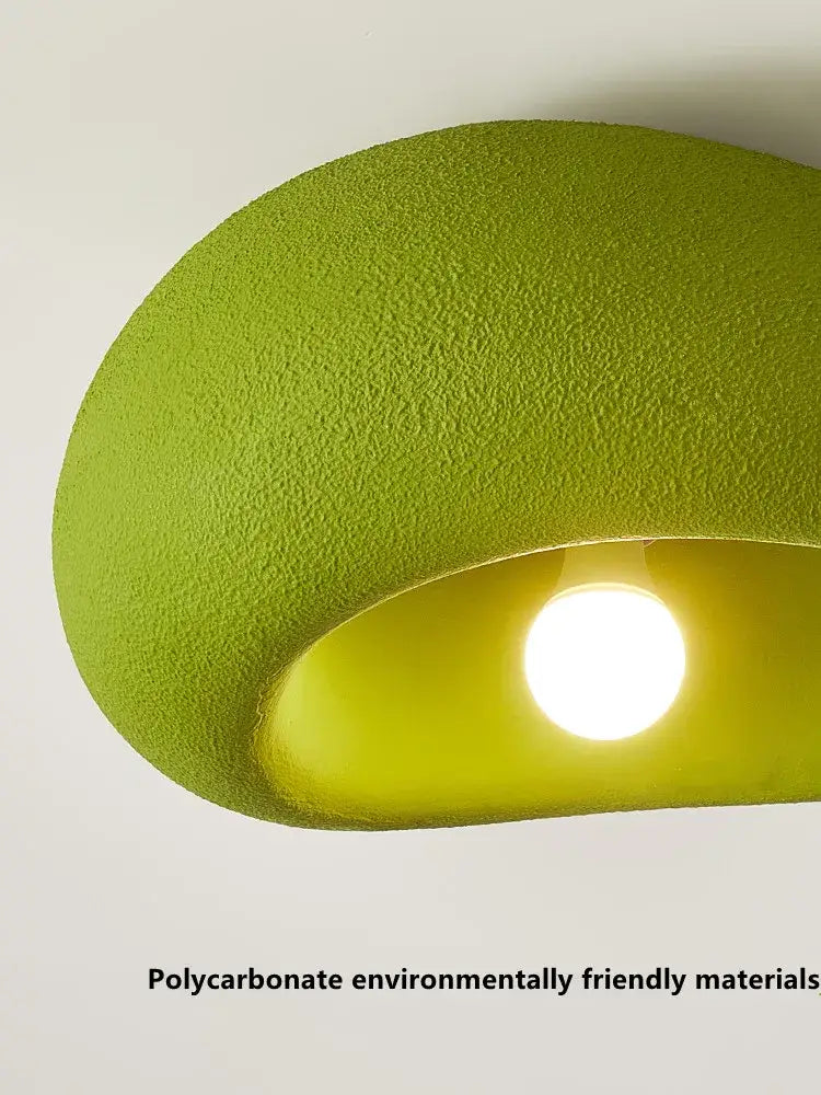 A modern nordic ceiling light with a curved lime green polycarbonate design for bedroom use