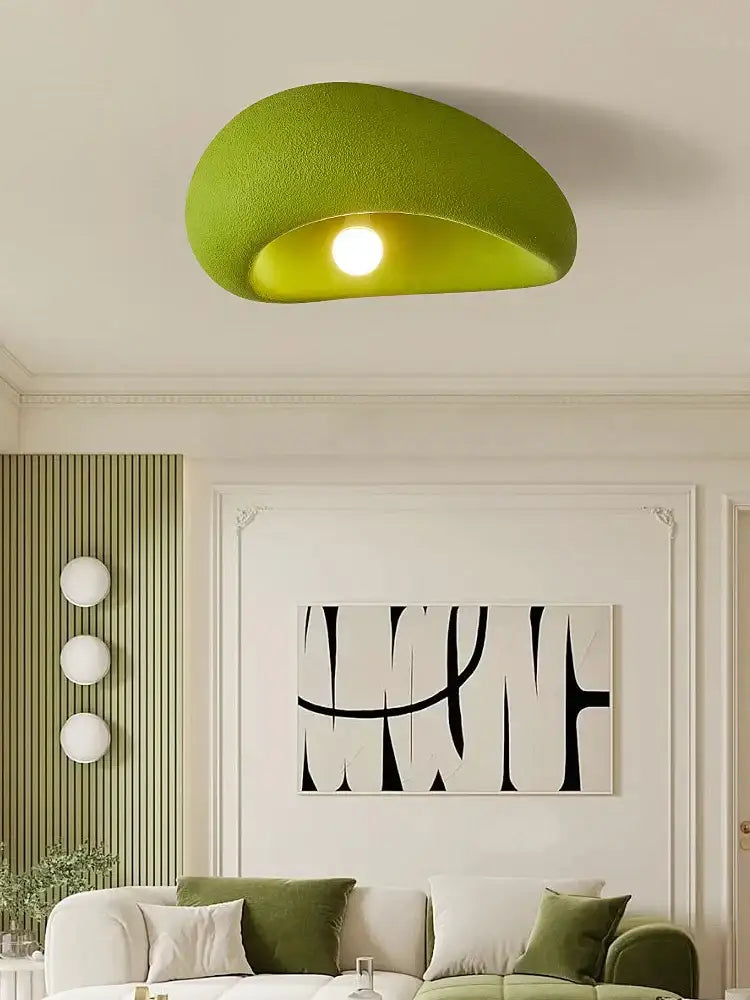 A nordic ceiling light in lime green fabric with a soft textured finish and curved half-moon shape for bedroom use