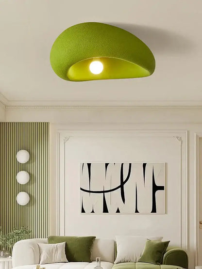 A nordic ceiling light in lime green fabric with a soft textured finish and curved half-moon shape for bedroom use