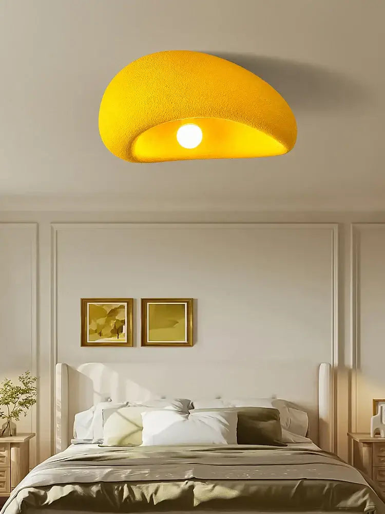 A vibrant yellow textured nordic ceiling light fixture with a modern curved design for bedroom use