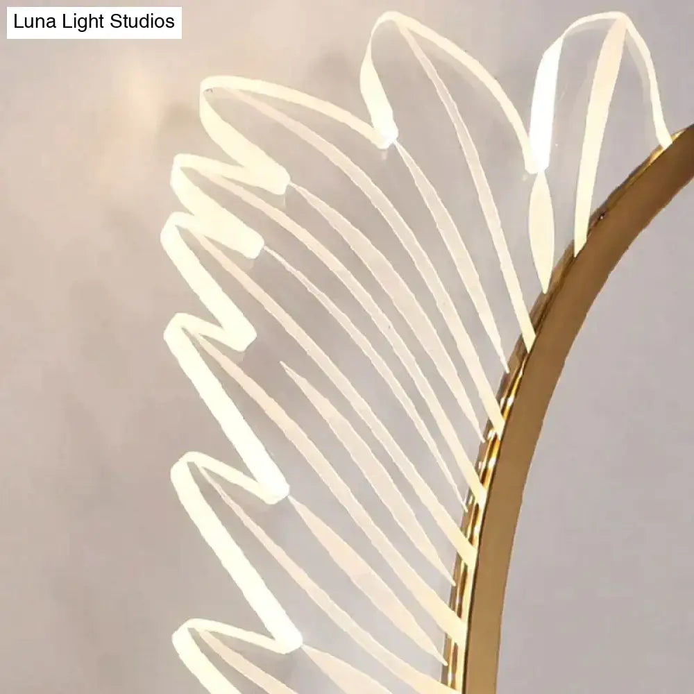 A nordic modern art gold feather wall lamp with a curved frame and warm glowing translucent led strips for bedrooms