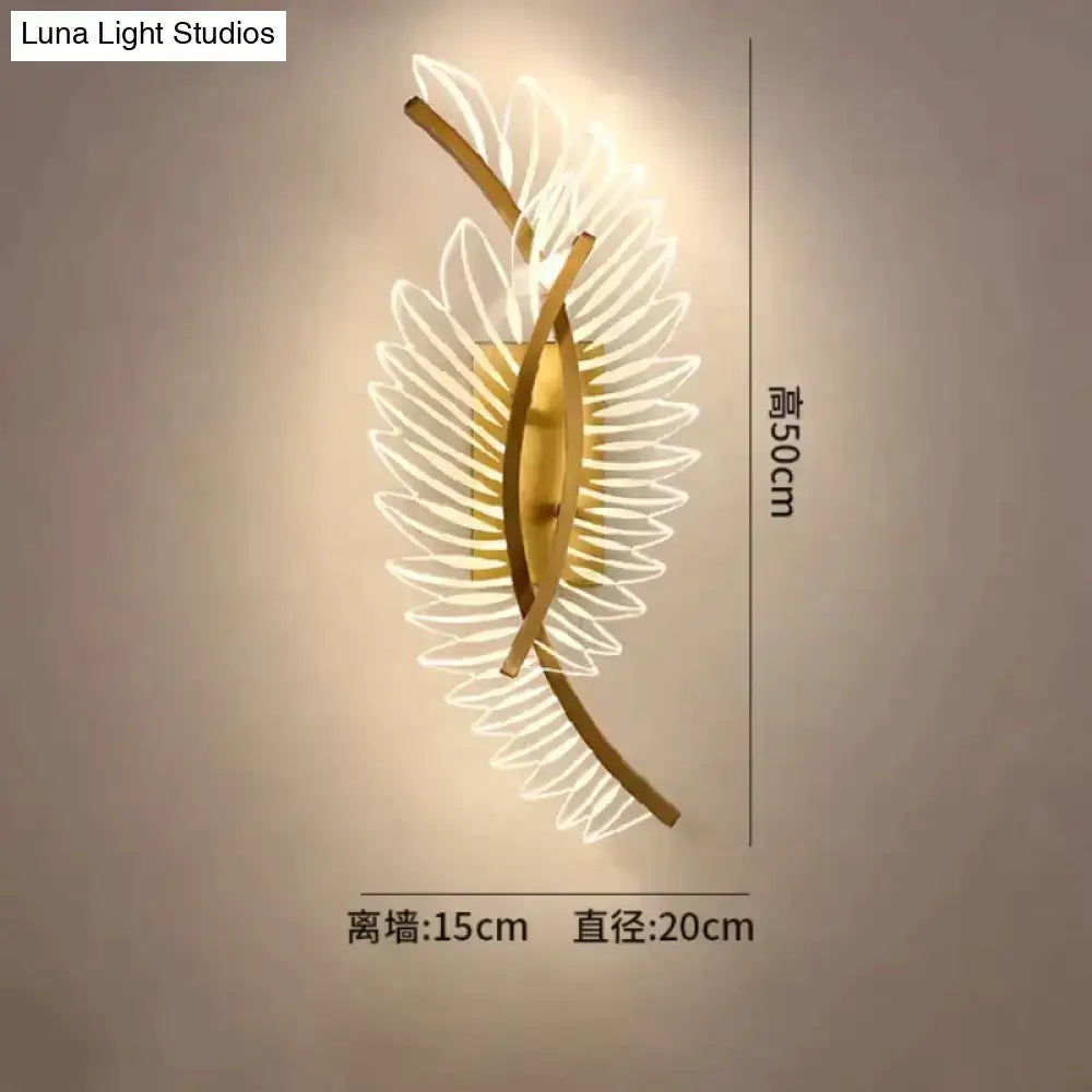 Gold-toned nordic modern art wall lamp shaped like a leaf with illuminated translucent petal details for bedside use
