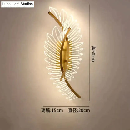 Gold-toned nordic modern art wall lamp shaped like a leaf with illuminated translucent petal details for bedside use