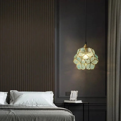 A delicate translucent green nordic modern petal acrylic pendant lamp with floral design hanging from the ceiling