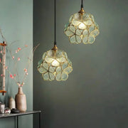 Two elegant translucent green glass petal acrylic pendant lamps with brass accents for bedroom or restaurant lighting