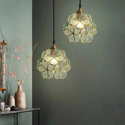 Two elegant translucent green glass petal acrylic pendant lamps with brass accents for bedroom or restaurant lighting