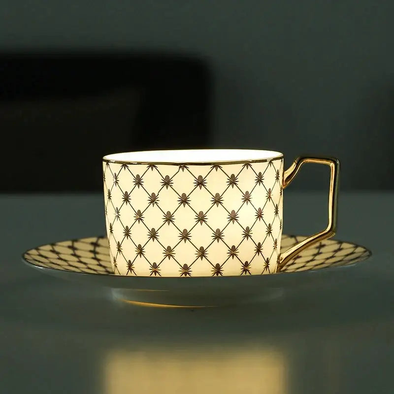 Cream-colored bone china coffee cup with gold rim handle and black diamond lattice pattern from nordic navy gold set