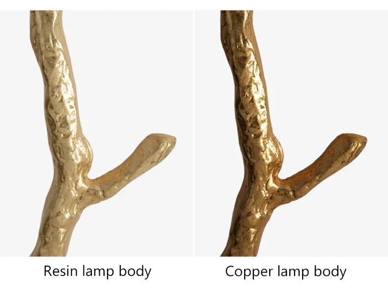 Golden textured floor lamp with tree branch design and ostrich feather accents for living room decor