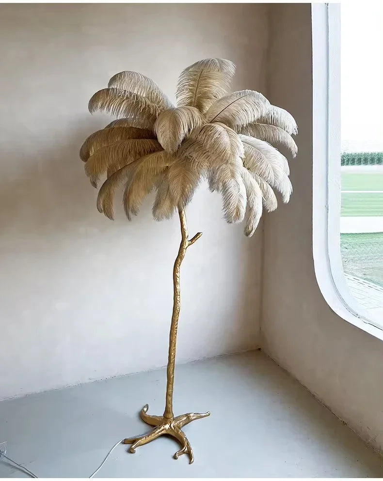 Golden feather floor lamp with slender branch-like stem and cream ostrich feathers for living room decor