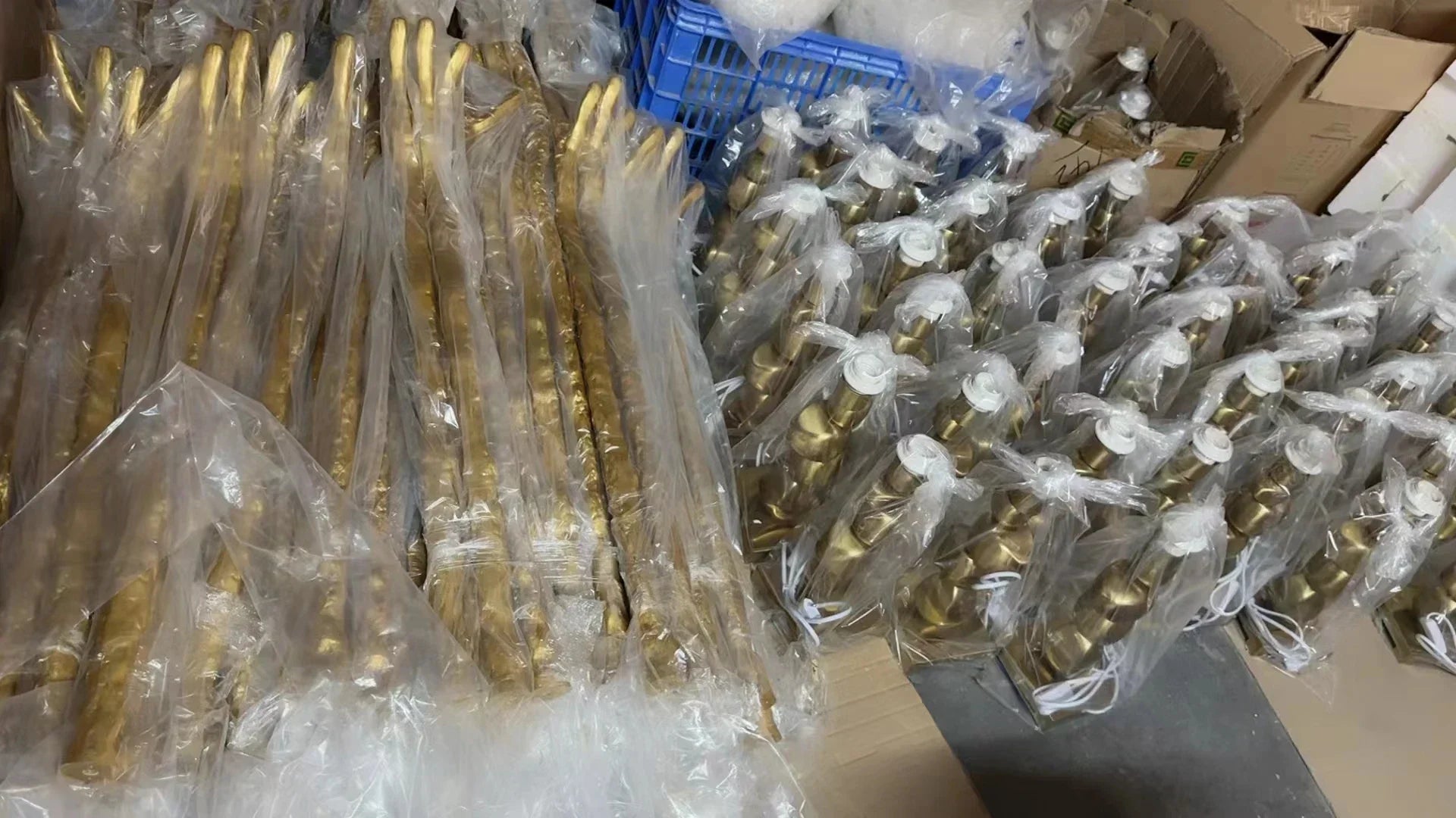 Golden brass-colored metal handles wrapped in clear plastic for nordic ostrich feather floor lamp in living room decor