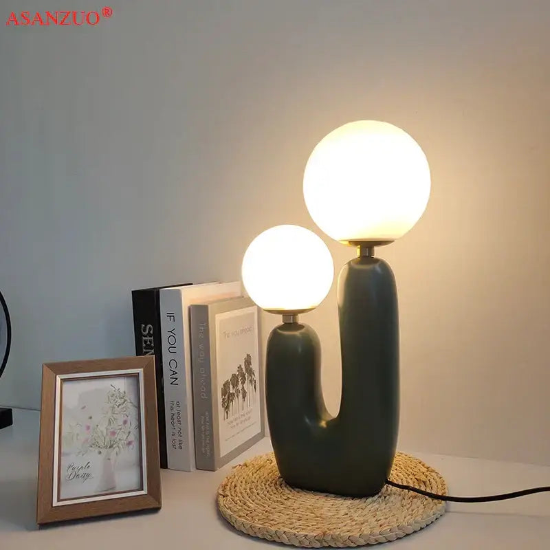 Modern green ceramic ball table lamp with two glowing glass ball shades for bedroom decor
