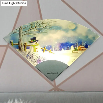 Nordic snowman led fan shaped wall light featuring a blue top hat snowman in a snowy winter scene for bedroom decor