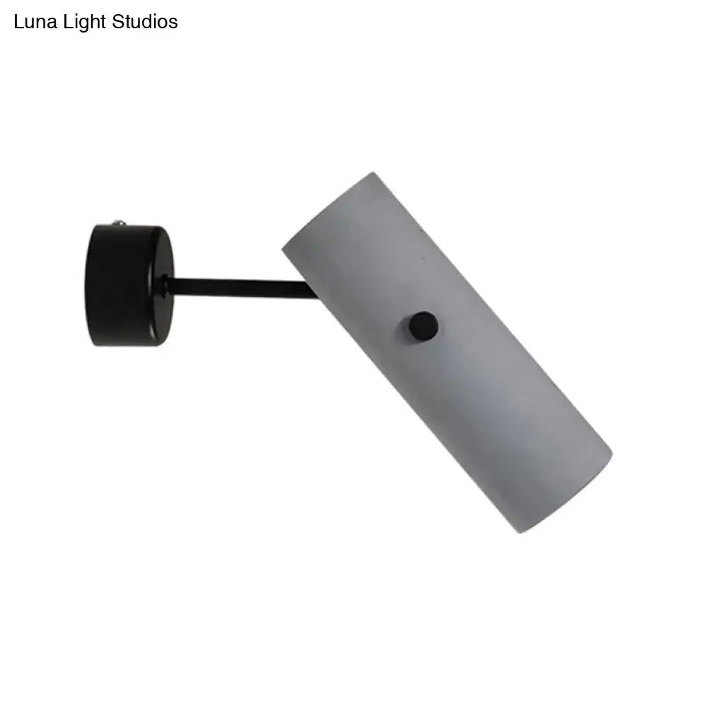 Modern gray cylindrical nordic style wall sconce with matte finish and black mounting bracket for bedroom lighting
