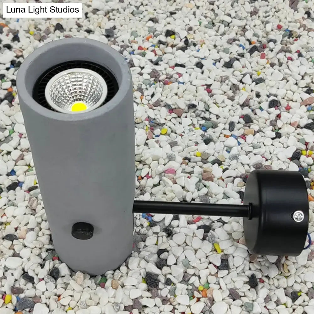 Nordic style gray cylindrical led wall sconce with black arm and base featuring visible cob light source for bedroom use