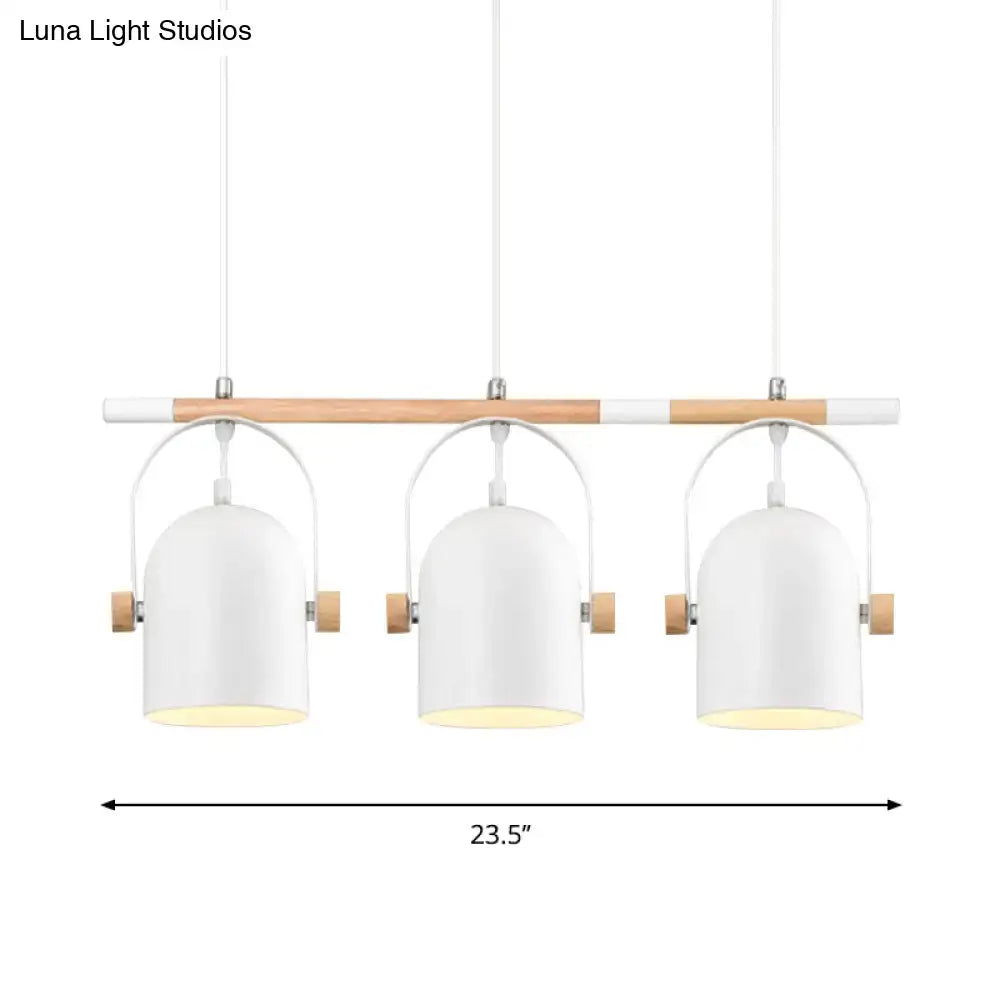 Modern white metal pendant light with wooden accents featuring three adjustable dome shades for island lighting