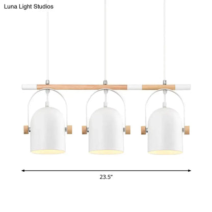Modern white metal pendant light with wooden accents featuring three adjustable dome shades for island lighting