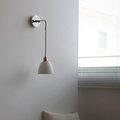 White ribbed ceramic led wall light with brass fixture and dark braided cord from decorbites ceramic led collection
