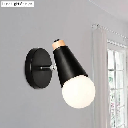 Black nordic sweet cone wall light with matte conical shade, bamboo base, and exposed frosted glass bulb for bedroom use